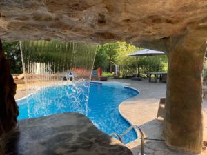 Looking at pool inside of custom cave by creative landscapes of Nebraska